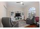 Comfortable den space features built-in shelving, large windows, and hardwood floors at 2399 Nw 53Rd Avenue Rd, Ocala, FL 34482