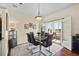 Dining area with modern table, six chairs, and doors leading to a screened-in outdoor space at 2399 Nw 53Rd Avenue Rd, Ocala, FL 34482