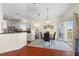 Eat-in kitchen with stainless steel appliances, a breakfast bar, and an adjacent dining area at 2399 Nw 53Rd Avenue Rd, Ocala, FL 34482