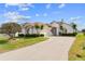 Charming stucco home with a well-manicured lawn and a long driveway at 2399 Nw 53Rd Avenue Rd, Ocala, FL 34482