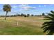 Expansive golf course view with palm trees under a blue sky creates a serene backdrop at 2399 Nw 53Rd Avenue Rd, Ocala, FL 34482