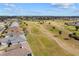 An aerial view of a beautiful golf course community with a pond, fairways, and manicured landscaping at 2399 Nw 53Rd Avenue Rd, Ocala, FL 34482