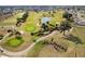 Aerial view showcasing the lush golf course, serene pond, and charming community at 2399 Nw 53Rd Avenue Rd, Ocala, FL 34482