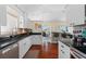Open kitchen featuring stainless steel appliances, black granite counters, and a breakfast bar at 2399 Nw 53Rd Avenue Rd, Ocala, FL 34482