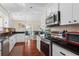 Bright kitchen with white cabinets, stainless steel appliances, and eat-in dining area at 2399 Nw 53Rd Avenue Rd, Ocala, FL 34482