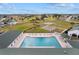 Aerial view of a large community pool, hot tub, and lounge area overlooking a scenic golf course at 2399 Nw 53Rd Avenue Rd, Ocala, FL 34482