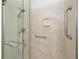 Close-up of a modern glass shower with grab bars and built-in soap dish for accessibility at 2399 Nw 53Rd Avenue Rd, Ocala, FL 34482
