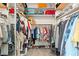 Well-organized walk-in closet with multiple shelves and hanging rods for clothing and accessories at 2399 Nw 53Rd Avenue Rd, Ocala, FL 34482