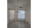 Cozy dining area with tile flooring and a stylish chandelier with views of the outdoors through vertical blinds at 2637 Ne 27Th St, Ocala, FL 34470