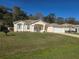 Charming one story home featuring a well maintained lawn, attached two-car garage, and a beautifully landscaped front yard at 2637 Ne 27Th St, Ocala, FL 34470