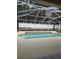Gorgeous in-ground pool features a screened enclosure, surrounding privacy fence, and concrete patio for lounging in the sun at 2637 Ne 27Th St, Ocala, FL 34470