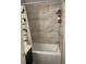 Bathroom showcasing tub and shower with tile walls at 2923 Antique Oaks Cir # 39, Winter Park, FL 32792