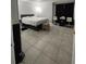 Bedroom with tiled floor, gray walls, a bed, and a table between two chairs at 2923 Antique Oaks Cir # 39, Winter Park, FL 32792