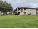 Inviting condo building featuring well-maintained landscaping and a lush green lawn at 2923 Antique Oaks Cir # 39, Winter Park, FL 32792