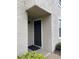 A front door with black paint stands out against the neutral tones of the building's exterior at 2923 Antique Oaks Cir # 39, Winter Park, FL 32792