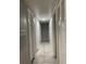 Hallway featuring neutral paint, ceramic tile flooring, multiple white doors, and overhead lighting at 2923 Antique Oaks Cir # 39, Winter Park, FL 32792