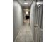 Hallway with tiled flooring, neutral walls, white doors, and an opening to the kitchen at 2923 Antique Oaks Cir # 39, Winter Park, FL 32792