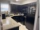 Kitchen features black appliances, tile backsplash and countertop at 2923 Antique Oaks Cir # 39, Winter Park, FL 32792