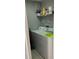Laundry room with white washer and dryer, overhead storage shelf, and cleaning supplies at 2923 Antique Oaks Cir # 39, Winter Park, FL 32792
