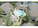 Aerial view of community pool area featuring lush landscaping and plenty of space for entertaining at 2923 Antique Oaks Cir # 39, Winter Park, FL 32792