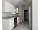 Kitchen featuring white cabinets, stainless steel appliances and granite countertops at 2949 Se 144Th Pl, Summerfield, FL 34491