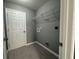 Laundry room with gray walls, tile floors, and a wire shelf above the hookups at 2963 Se 144Th Pl, Summerfield, FL 34491