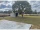 View of the backyard shed next to a large tree at 4 Pine Pass Ter, Ocala, FL 34472