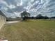View of the large, grassy backyard of the property with a storage shed at 4 Pine Pass Ter, Ocala, FL 34472