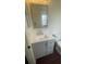 Updated bathroom featuring a modern gray vanity with storage and a sleek white countertop and mirror at 4 Pine Pass Ter, Ocala, FL 34472