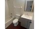 Well-lit bathroom with a white tiled shower-tub, gray vanity, white countertop, and a large mirror at 4 Pine Pass Ter, Ocala, FL 34472