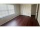 A sunlit bedroom featuring laminate floors and a double door closet at 4 Pine Pass Ter, Ocala, FL 34472
