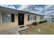Home exterior featuring a black front door and a manicured lawn at 4 Pine Pass Ter, Ocala, FL 34472