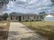 Charming single-story home with a well-manicured front yard and a long driveway at 4 Pine Pass Ter, Ocala, FL 34472