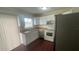 Cozy kitchen featuring white cabinets, stainless steel appliances, and wood floor at 4 Pine Pass Ter, Ocala, FL 34472