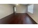 A well-lit living room area with a fan and wood floors at 4 Pine Pass Ter, Ocala, FL 34472