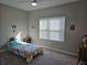 Cozy bedroom with carpet, natural light, and colorful bedding and decor at 4838 Sw 130Th St, Ocala, FL 34473