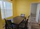 A dining room that is bright and cheerful with four chairs and decor at 4838 Sw 130Th St, Ocala, FL 34473