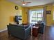 Comfortable living room with wood floors, ceiling fan, and sliding doors leading to the backyard at 4838 Sw 130Th St, Ocala, FL 34473