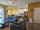 Spacious living room open to the kitchen with wood floors and natural light at 4838 Sw 130Th St, Ocala, FL 34473