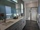 Bright main bathroom featuring a double vanity, frameless shower, and sleek tile at 4838 Sw 130Th St, Ocala, FL 34473