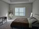 A bright bedroom featuring a decorative tray ceiling, neutral tones and a plush carpet at 4838 Sw 130Th St, Ocala, FL 34473