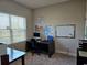 Office space with natural light, large desk, carpet, and a whiteboard at 4838 Sw 130Th St, Ocala, FL 34473