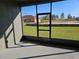 View from screened patio shows the spacious backyard and a neighboring home at 4838 Sw 130Th St, Ocala, FL 34473