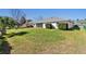 Expansive backyard with lush green grass and view of the home's rear exterior at 5040 Nw 35Th St, Ocala, FL 34482