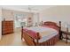 Cozy bedroom featuring wood floors, a ceiling fan, and a comfortable bed with bedside tables at 5040 Nw 35Th St, Ocala, FL 34482
