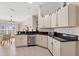 Bright kitchen featuring white cabinets, granite countertops, and stainless steel appliances at 5040 Nw 35Th St, Ocala, FL 34482