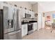 Bright kitchen featuring white cabinets, granite countertops, and stainless steel appliances at 5040 Nw 35Th St, Ocala, FL 34482