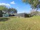 Spacious backyard with a screened-in pool and storage shed, surrounded by mature trees at 5906 Sw 108Th St, Ocala, FL 34476