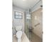 Modern bathroom with a glass shower, tiled floors, and grab bar for accessibility at 5906 Sw 108Th St, Ocala, FL 34476