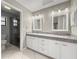 Bathroom features dual sinks, granite countertops, and a walk-in shower at 5906 Sw 108Th St, Ocala, FL 34476